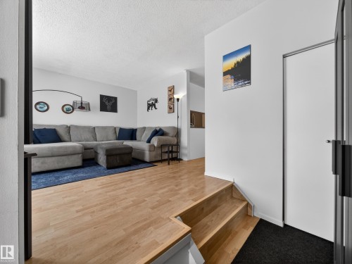 Living area with wood finished floors and a textured ceiling - 4603 32 Avenue, Edmonton, AB - Indoor