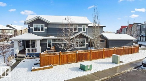 Snow covered back of property featuring a residential view, a wooden deck, and a gazebo - 4303 Prowse Link, Edmonton, AB - Outdoor