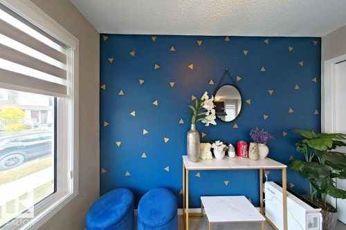 with an accent wall and a textured ceiling - 4303 Prowse Link, Edmonton, AB - Indoor Photo Showing Other Room