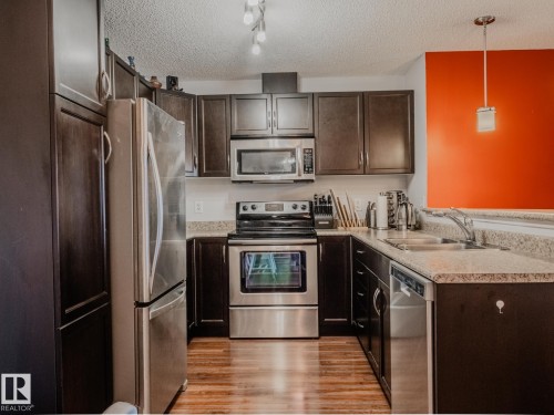 409 6070 Schonsee Way, Edmonton, AB - Indoor Photo Showing Kitchen With Stainless Steel Kitchen With Double Sink