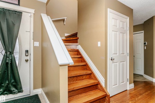 Staircase with a textured ceiling and wood finished floors - 607 Windross Crescent, Edmonton, AB - Indoor Photo Showing Other Room