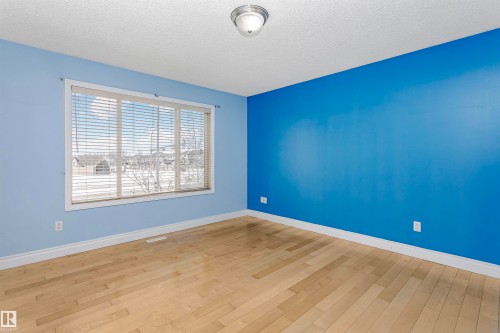 Empty room with a textured ceiling and light wood finished floors - 607 Windross Crescent, Edmonton, AB - Indoor Photo Showing Other Room