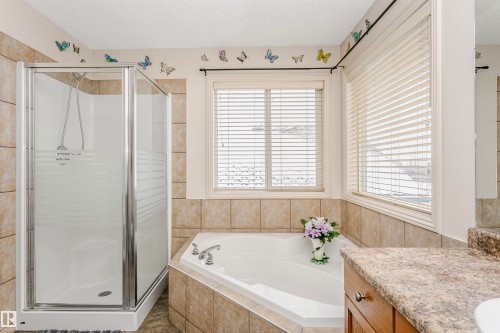 Bathroom with vanity, a shower stall, a textured ceiling, and a bath - 607 Windross Crescent, Edmonton, AB - Indoor Photo Showing Bathroom