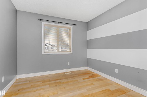 Empty room with light wood finished floors and a textured ceiling - 607 Windross Crescent, Edmonton, AB - Indoor Photo Showing Other Room