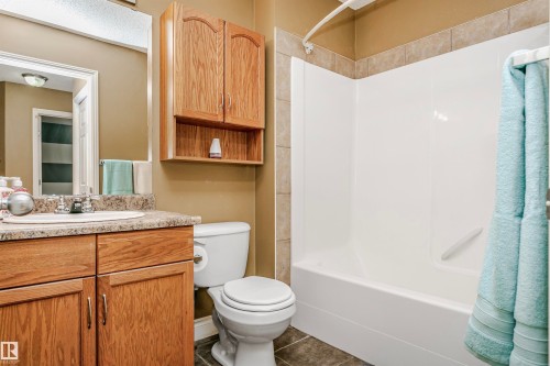 Full bathroom with vanity, shower / bathtub combination, and dark tile patterned floors - 607 Windross Crescent, Edmonton, AB - Indoor Photo Showing Bathroom