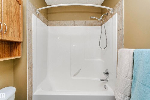 Bathroom with bathtub / shower combination and a textured ceiling - 607 Windross Crescent, Edmonton, AB - Indoor Photo Showing Bathroom