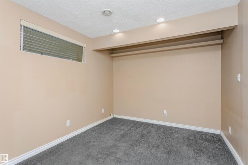 Finished basement featuring dark colored carpet, a textured ceiling, and recessed lighting - 607 Windross Crescent, Edmonton, AB - Indoor Photo Showing Other Room