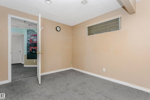 Unfurnished bedroom with light colored carpet and a textured ceiling - 607 Windross Crescent, Edmonton, AB - Indoor Photo Showing Other Room