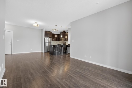 Unfurnished living room with dark wood-style floors - 206 812 Welsh Drive, Edmonton, AB - Indoor