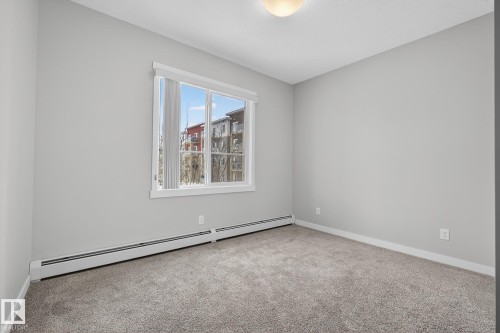 Spare room featuring a baseboard heating unit and carpet - 206 812 Welsh Drive, Edmonton, AB - Indoor Photo Showing Other Room