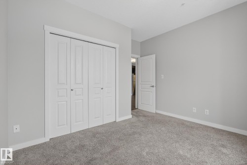 Unfurnished bedroom with carpet floors and a closet - 206 812 Welsh Drive, Edmonton, AB - Indoor