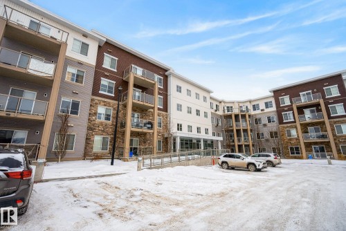Snow covered property featuring a view of apartment building / complex and uncovered parking - 206 812 Welsh Drive, Edmonton, AB - Outdoor With Balcony With Facade
