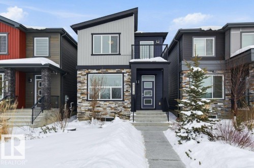 Modern home featuring stone siding - 8018 Kiriak Link, Edmonton, AB - Outdoor With Balcony With Facade
