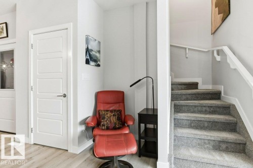 Staircase featuring baseboards and wood finished floors - 8018 Kiriak Link, Edmonton, AB - Indoor Photo Showing Other Room