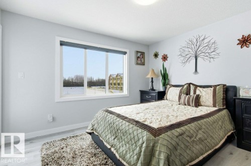 Bedroom with light wood-style floors and baseboards - 8018 Kiriak Link, Edmonton, AB - Indoor Photo Showing Bedroom