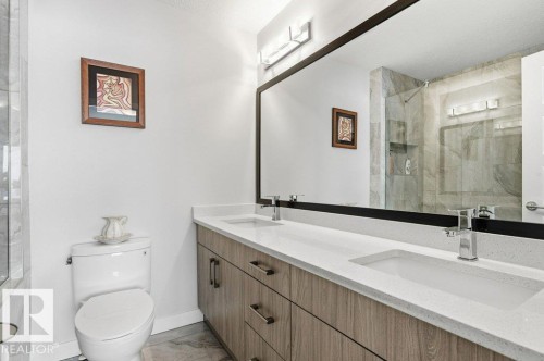 Bathroom featuring double vanity and a marble finish shower - 8018 Kiriak Link, Edmonton, AB - Indoor Photo Showing Bathroom