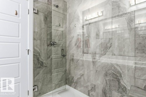 Bathroom with a marble finish shower - 8018 Kiriak Link, Edmonton, AB - Indoor Photo Showing Bathroom