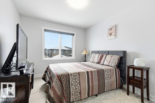 Bedroom with baseboards and light wood-style flooring - 8018 Kiriak Link, Edmonton, AB - Indoor Photo Showing Bedroom