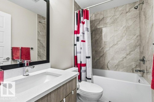 Bathroom with vanity, shower / tub combo, and a textured ceiling - 8018 Kiriak Link, Edmonton, AB - Indoor Photo Showing Bathroom