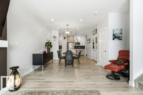 Dining room with light wood-type flooring and suspended lighting - 8018 Kiriak Link, Edmonton, AB - Indoor