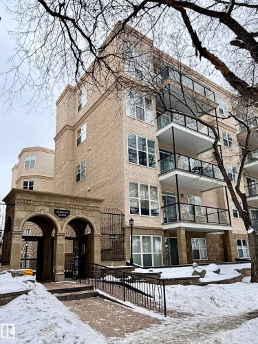 Snow covered property with a view of apartment building / complex - 115 11039 83 Avenue, Edmonton, AB - Outdoor