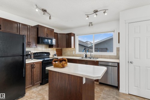 419 Songhurst Place, Leduc, AB - Indoor Photo Showing Kitchen With Double Sink