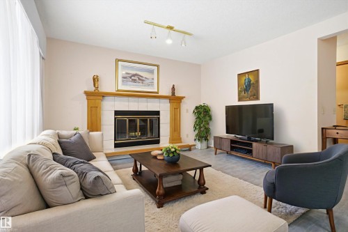 Garage converted to office space but easily converted back - 1 Heritage Boulevard, St. Albert, AB - Indoor Photo Showing Living Room With Fireplace