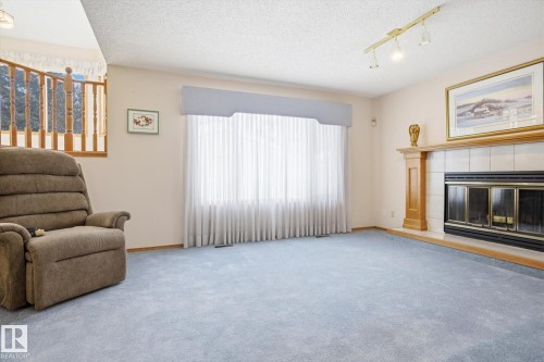 1 Heritage Boulevard, St. Albert, AB - Indoor Photo Showing Living Room With Fireplace