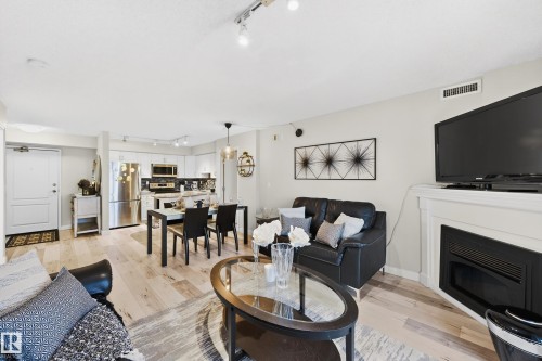 703 10649 Saskatchewan Drive, Edmonton, AB - Indoor Photo Showing Living Room With Fireplace