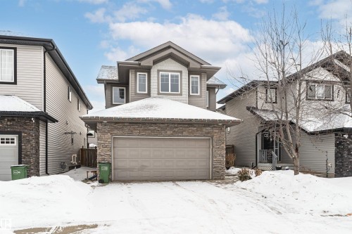 Craftsman-style house featuring stone siding and a garage - 115 57 Street, Edmonton, AB - Outdoor