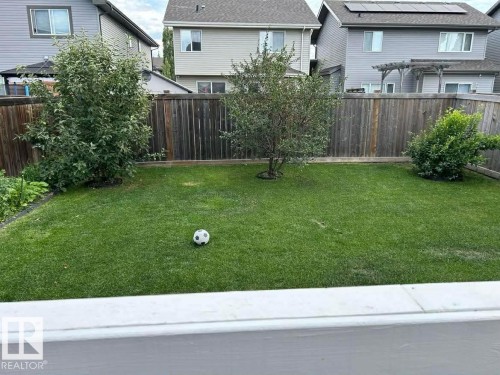 Fenced backyard with a residential view - 115 57 Street, Edmonton, AB - Outdoor With Deck Patio Veranda