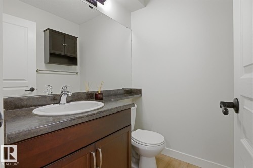 Half bath featuring vanity and light wood finished floors - 73 Keystone Crescent Crescent, Leduc, AB - Indoor Photo Showing Bathroom