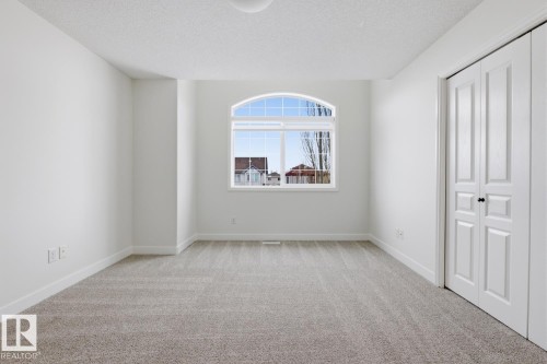 Unfurnished bedroom with light colored carpet, a closet, and a textured ceiling - 73 Keystone Crescent Crescent, Leduc, AB - Indoor Photo Showing Other Room