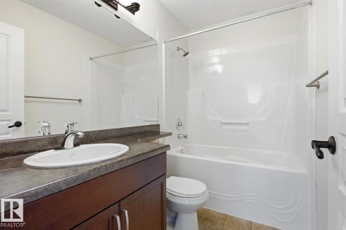 Full bathroom featuring vanity, shower / bathtub combination, and light tile patterned floors - 73 Keystone Crescent Crescent, Leduc, AB - Indoor Photo Showing Bathroom