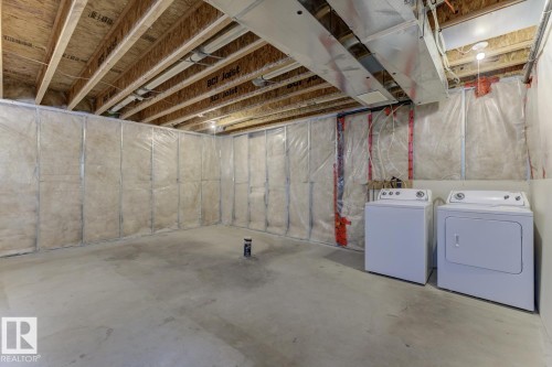 Unfinished below grade area featuring washer and clothes dryer - 73 Keystone Crescent Crescent, Leduc, AB - Indoor Photo Showing Laundry Room