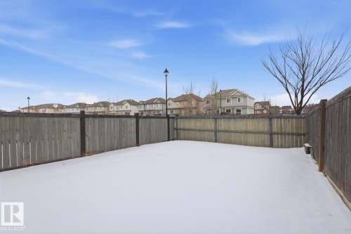Fenced backyard with a residential view - 73 Keystone Crescent Crescent, Leduc, AB - Outdoor