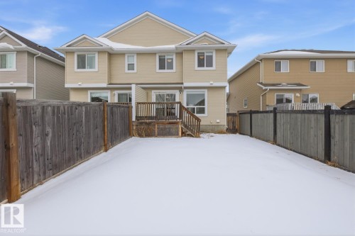Snow covered house featuring a fenced backyard and a wooden deck - 73 Keystone Crescent Crescent, Leduc, AB - Outdoor