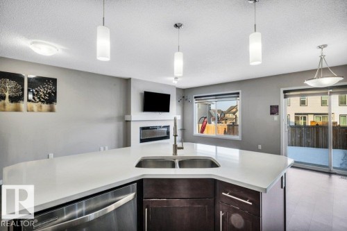 2437 Cassidy Way, Edmonton, AB - Indoor Photo Showing Kitchen With Fireplace With Double Sink