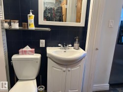 Bathroom featuring tile walls, vanity, tasteful backsplash, and a closet - 