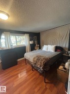 Bedroom featuring wood finished floors and a textured ceiling - 