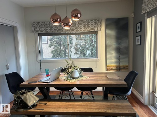 Dining area with wood finished floors and a chandelier - 11406 96 Street, Edmonton, AB - Indoor
