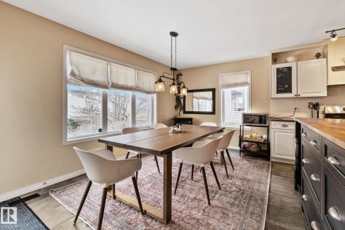 Dining space with plenty of natural light, a chandelier, and dark tile patterned floors - 502 Westerra Boulevard, Stony Plain, AB - Indoor Photo Showing Other Room