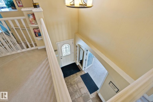 Entrance foyer with light carpet, a high ceiling, a chandelier, and french doors - 502 Westerra Boulevard, Stony Plain, AB - Indoor Photo Showing Other Room