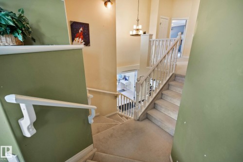 Stairway featuring suspended lighting, carpet floors, and a high ceiling - 502 Westerra Boulevard, Stony Plain, AB - Indoor Photo Showing Other Room