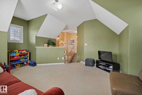 Carpeted living area with baseboards and lofted ceiling - 502 Westerra Boulevard, Stony Plain, AB - Indoor