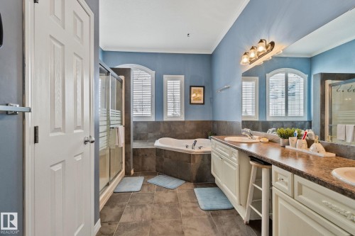 Bathroom featuring double vanity, a bath, crown molding, a stall shower, and healthy amount of natural light - 502 Westerra Boulevard, Stony Plain, AB - Indoor Photo Showing Bathroom