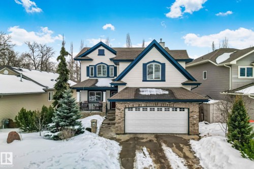 View of front facade featuring a garage, a balcony, brick siding, a chimney, and driveway - 502 Westerra Boulevard, Stony Plain, AB - Outdoor With Facade