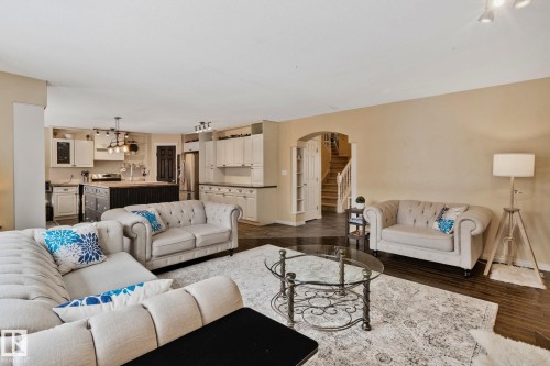 Living room with arched walkways and dark wood-style floors - 502 Westerra Boulevard, Stony Plain, AB - Indoor Photo Showing Living Room
