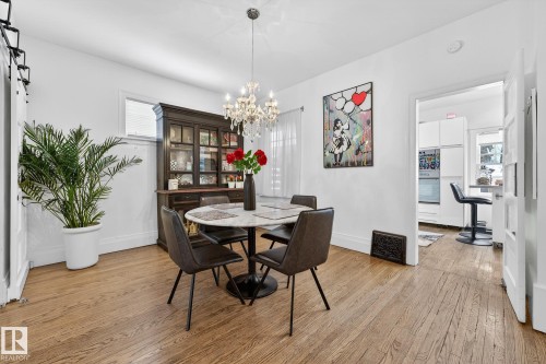 Dining space featuring light wood finished floors and suspended lighting - 10523 127 Street, Edmonton, AB - Indoor Photo Showing Dining Room