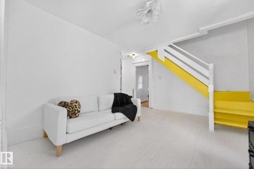 Living room featuring stairway and light wood-style floors - 10523 127 Street, Edmonton, AB - Indoor Photo Showing Other Room